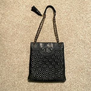 Tory Burch black handbag with gold chain.